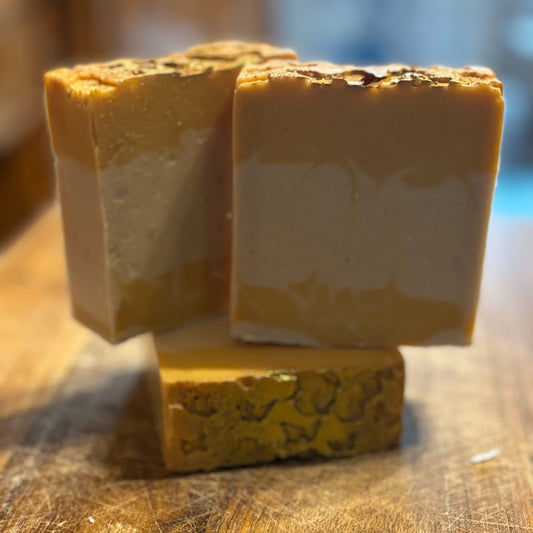 Honeysuckle scented -5 oz  goat milk soap with yellow & white layers, butterfly top accented with glitter