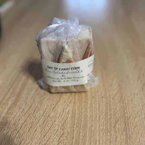 5 oz goat milk soap with Pina Colada Smoothie scent in a Candy Corn design packed in a sheer organza bag