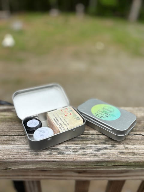 Mini tin containing a sample soap, sample lotion and sample lip balm all various scents/flavors