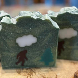 A Camo Soap with a Yeti heating to a pine tree and a cloud over it's head